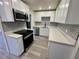 Modern kitchen featuring stainless steel appliances, subway tile backsplash and stone countertops at 8320 Dominguin St, Orlando, FL 32817