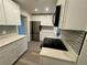 Well-lit kitchen with stainless steel appliances, subway tile backsplash and white cabinetry at 8320 Dominguin St, Orlando, FL 32817
