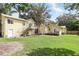 Expansive backyard with lush lawn showcasing the home's architecture and outdoor potential at 835 Antonette Ave, Winter Park, FL 32789
