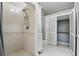 Bathroom shower featuring a shower-head and storage adjacent to the closet at 835 Antonette Ave, Winter Park, FL 32789