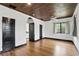 Bedroom featuring hardwood floors, multiple doors, and unique ceiling at 835 Antonette Ave, Winter Park, FL 32789