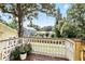Wooden deck with white railing overlooking the yard and neighborhood at 835 Antonette Ave, Winter Park, FL 32789