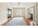 Open dining room with hardwood floors, a modern chandelier, and french doors leading to the kitchen at 835 Antonette Ave, Winter Park, FL 32789