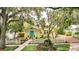 Charming yellow home with a lush front yard, white picket fence, and a bright blue front door at 835 Antonette Ave, Winter Park, FL 32789