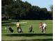 Picturesque golf course with players, manicured greens, and mature trees at 835 Antonette Ave, Winter Park, FL 32789
