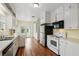 Functional kitchen with classic white cabinets, modern appliances, and hardwood floors at 835 Antonette Ave, Winter Park, FL 32789