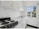 White kitchen featuring vintage stove, counter, and bright window view at 835 Antonette Ave, Winter Park, FL 32789