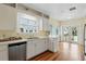Bright kitchen featuring white cabinetry, stainless steel appliances, and hardwood floors at 835 Antonette Ave, Winter Park, FL 32789