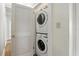 Stacked white washer and dryer adjacent to a closet at 835 Antonette Ave, Winter Park, FL 32789
