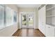 Bright living room with hardwood floors, window blinds, and a patio view through the French doors at 835 Antonette Ave, Winter Park, FL 32789
