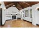 Living room featuring hardwood floors, a fireplace, and beamed ceiling at 835 Antonette Ave, Winter Park, FL 32789