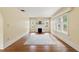 Sunlit living room showcasing hardwood floors, a decorative fireplace, and bright windows at 835 Antonette Ave, Winter Park, FL 32789