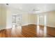 Well-lit living room with hardwood floors and a doorway leading to another room, filled with natural light at 835 Antonette Ave, Winter Park, FL 32789