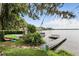 Picturesque waterfront property featuring a private dock, boat lift, and lush landscaping at 835 Antonette Ave, Winter Park, FL 32789