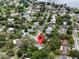 Aerial view pinpointing the home's location within a residential neighborhood near a lake at 8404 Singapore Ct, Orlando, FL 32817