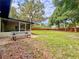 View of screened-in patio with picnic table, patio, and a large grassy yard at 8404 Singapore Ct, Orlando, FL 32817