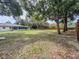 Spacious backyard featuring a screened lanai, picnic table, and mature trees providing ample shade at 8404 Singapore Ct, Orlando, FL 32817
