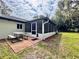 Side exterior view of home with large screened patio and backyard at 8404 Singapore Ct, Orlando, FL 32817