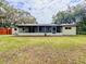 Back exterior view of home with large screened in patio overlooking the spacious backyard at 8404 Singapore Ct, Orlando, FL 32817