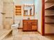 Bathroom featuring a wooden vanity, tile floors, and shower with grab bars at 8404 Singapore Ct, Orlando, FL 32817