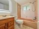 Bathroom featuring tiled shower/tub with updated vanity and mirror, great for a quick refresh at 8404 Singapore Ct, Orlando, FL 32817
