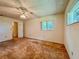 Bright bedroom featuring a ceiling fan, two windows, and an open closet space at 8404 Singapore Ct, Orlando, FL 32817