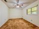Cozy bedroom with neutral carpet, ceiling fan, and natural light, perfect for relaxation and rest at 8404 Singapore Ct, Orlando, FL 32817