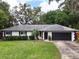 Charming single-story home features a well-manicured lawn and a two-car garage in a tranquil neighborhood at 8404 Singapore Ct, Orlando, FL 32817