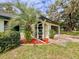 Landscaped exterior with a palm tree, potted plants, and a neatly maintained lawn, adding curb appeal at 8404 Singapore Ct, Orlando, FL 32817