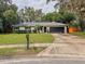 Beautifully maintained single-story house with a well-kept lawn, a driveway, and an attached two-car garage at 8404 Singapore Ct, Orlando, FL 32817