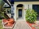 Inviting front porch with potted plants and a well-manicured entrance, creating a warm welcome at 8404 Singapore Ct, Orlando, FL 32817