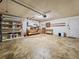 Spacious garage with workbench, shelving, and ample storage space for tools and equipment at 8404 Singapore Ct, Orlando, FL 32817