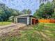 Attached two-car garage with a black door complemented by a fenced-in backyard and a well-maintained lawn at 8404 Singapore Ct, Orlando, FL 32817