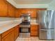 Bright kitchen features stainless steel appliances, counter space and wooden cabinetry at 8404 Singapore Ct, Orlando, FL 32817