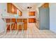 Well-lit kitchen features stainless steel appliances, a breakfast bar and tile flooring at 8404 Singapore Ct, Orlando, FL 32817