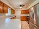 Bright kitchen features a stainless steel refrigerator and plenty of counter space at 8404 Singapore Ct, Orlando, FL 32817