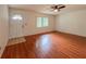 Bright living room with hardwood floors, a ceiling fan, and a window, creating a cozy atmosphere at 8404 Singapore Ct, Orlando, FL 32817