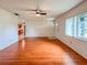 Spacious living room featuring wood floors, a ceiling fan and bright natural light at 8404 Singapore Ct, Orlando, FL 32817