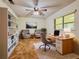 Comfortable home office with built-in bookshelves, desk, and seating area for a productive work environment at 8404 Singapore Ct, Orlando, FL 32817