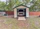 View of the backyard outbuilding with a ramp, offering extra storage space at 8404 Singapore Ct, Orlando, FL 32817