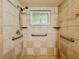 Accessible shower with grab bars, tile surround, and handheld shower head fixture at 8404 Singapore Ct, Orlando, FL 32817