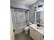 Bright bathroom with modern fixtures, a shower-tub and updated vanity at 9918 Turf Way # 5, Orlando, FL 32837
