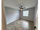 Comfortable bedroom with ceiling fan, new floors, and a large window at 9918 Turf Way # 5, Orlando, FL 32837