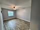 Cozy bedroom featuring updated flooring and natural light from the window at 9918 Turf Way # 5, Orlando, FL 32837