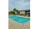 Community pool with lounge chairs and lush landscaping, perfect for relaxation and recreation at 9918 Turf Way # 5, Orlando, FL 32837