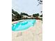 Sparkling community pool surrounded by lush greenery and lounge chairs offering a resort-like atmosphere at 9918 Turf Way # 5, Orlando, FL 32837