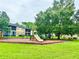 Community playground with play equipment and mature trees provides outdoor activities for children at 9918 Turf Way # 5, Orlando, FL 32837