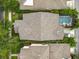 An aerial view highlighting the home's roof, lush backyard foliage, and screened-in pool area, offering a private outdoor space at 12641 Arley Dr, Windermere, FL 34786