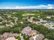 Aerial view of a well-maintained home with a screened-in pool, nestled in a community with lush trees and landscaping at 12641 Arley Dr, Windermere, FL 34786