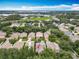 Expansive aerial view of a residential neighborhood, highlighting the property's location near a lake at 12641 Arley Dr, Windermere, FL 34786